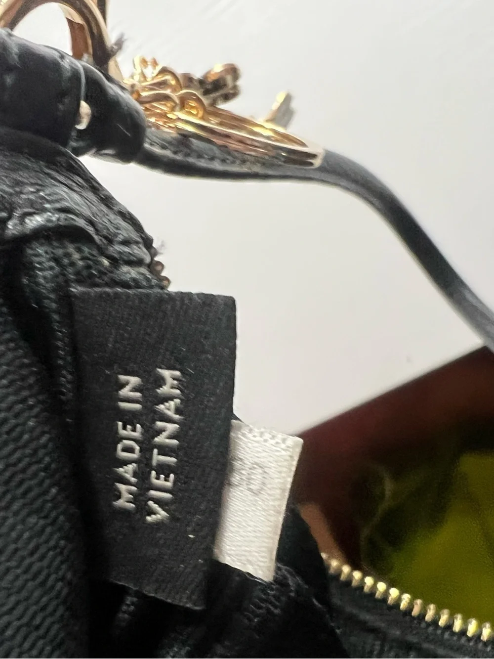 Coach Black Pebbled Leather Wristlet with Gold Floral Charm